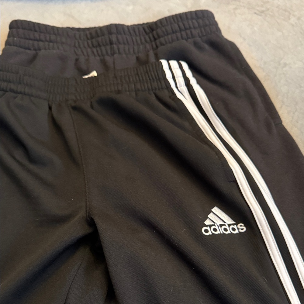 2 pair or Adidas Kids Black pants. One is a Joggers and the other a sweat pants